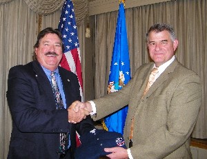 Steve Kelley (l), regional vice president, presents Thomas Entwistle, director of analysis and lessons learned/Air Force Smart Operations for the 21st Century (AFSO21), Air Combat Command, Langley Air Force Base, with a chapter polo shirt following his presentation at the November meeting.